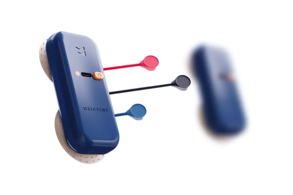 Studio rendering of the Kinvent K-Myo wireless EMG sensor pod in blue with three thin colored electrode leads (red, black, and blue), isolated on a transparent background with a blurred duplicate in the background