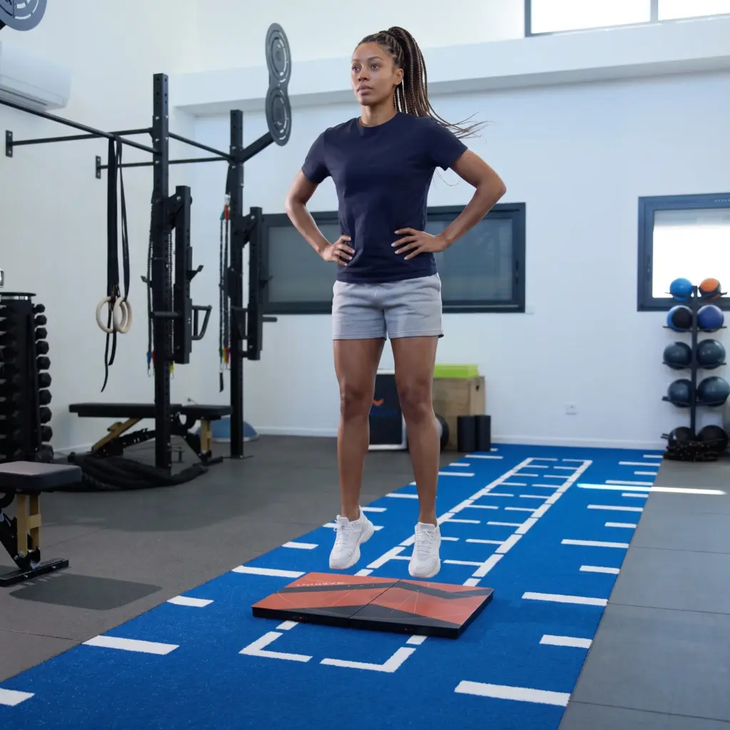 young woman doing a CMJ on K-Deltas force plate from KINVENT